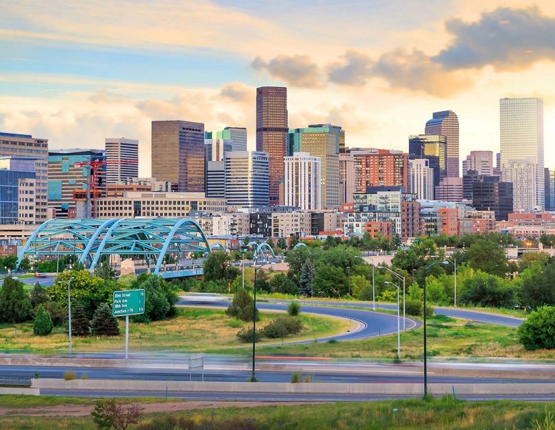 denver skyline and highway at dusk